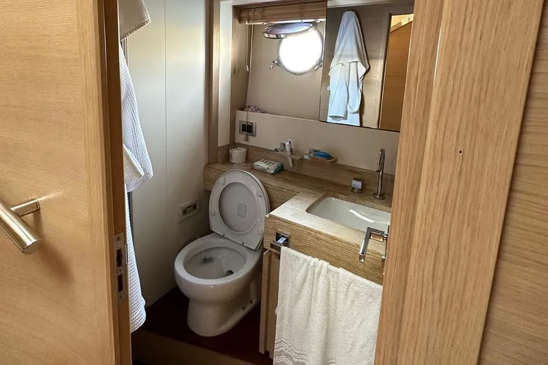  Yacht Photos Pics Bathroom interior of a 2012 Azimut 78 yacht with wooden accents and modern fixtures.