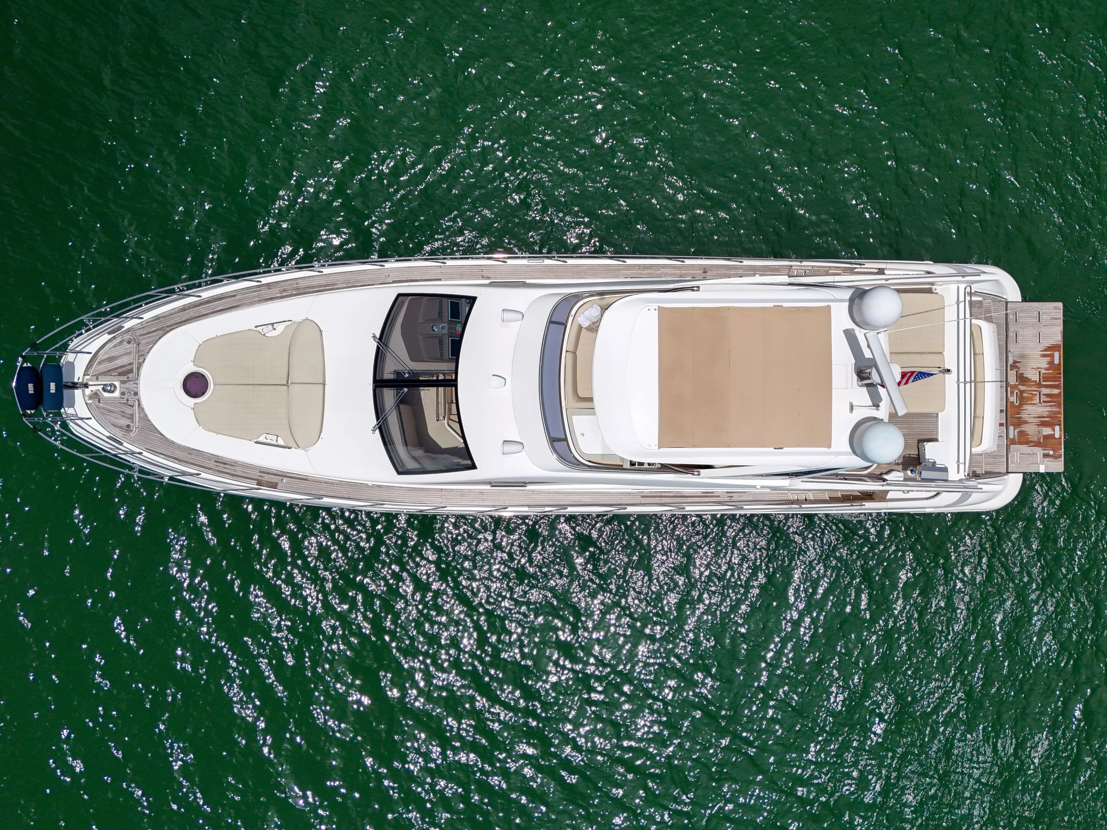  Yacht Photos Pics Aerial view of 2012 Azimut 64 Flybridge yacht on green water.