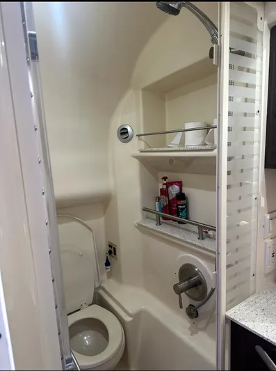 Pocket Change Yacht Photos Pics Bathroom interior of 2016 Sea Ray 370 Sundancer yacht, featuring shower and toilet amenities.