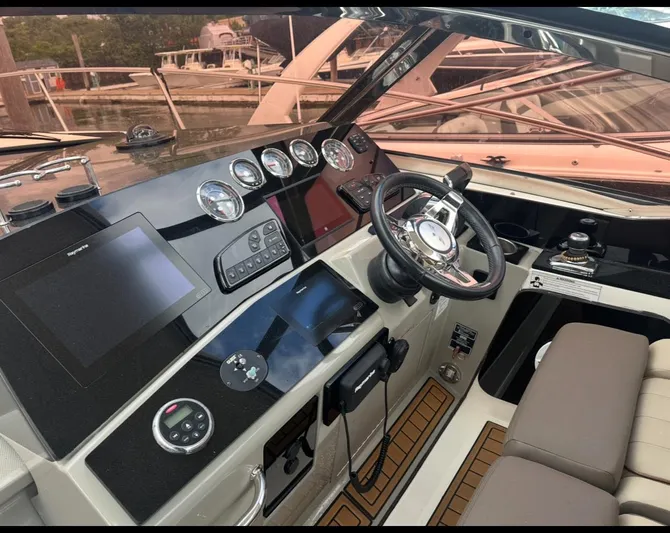 Pocket Change Yacht Photos Pics 2016 Sea Ray 370 Sundancer helm with modern controls and navigation equipment.