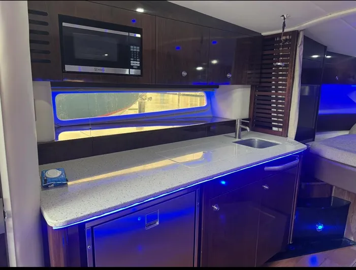 Pocket Change Yacht Photos Pics Luxurious interior of 2016 Sea Ray 370 Sundancer yacht with modern kitchen amenities.