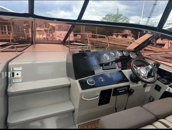 Pocket Change Yacht Photos Pics Cockpit of 2016 Sea Ray 370 Sundancer with modern controls and steering wheel.