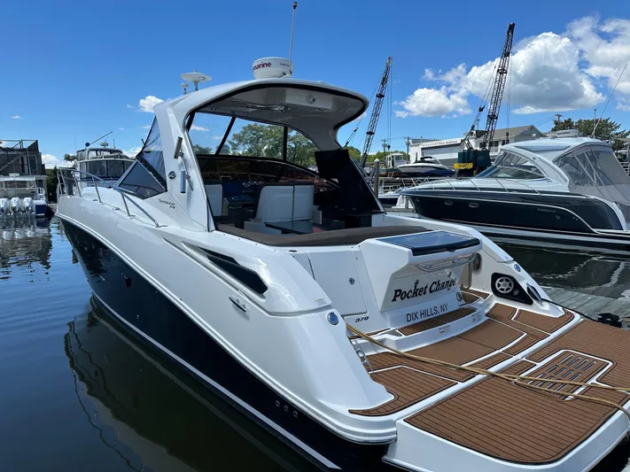 Pocket Change Yacht Photos Pics 2016 Sea Ray 370 Sundancer yacht docked at marina under clear blue sky.
