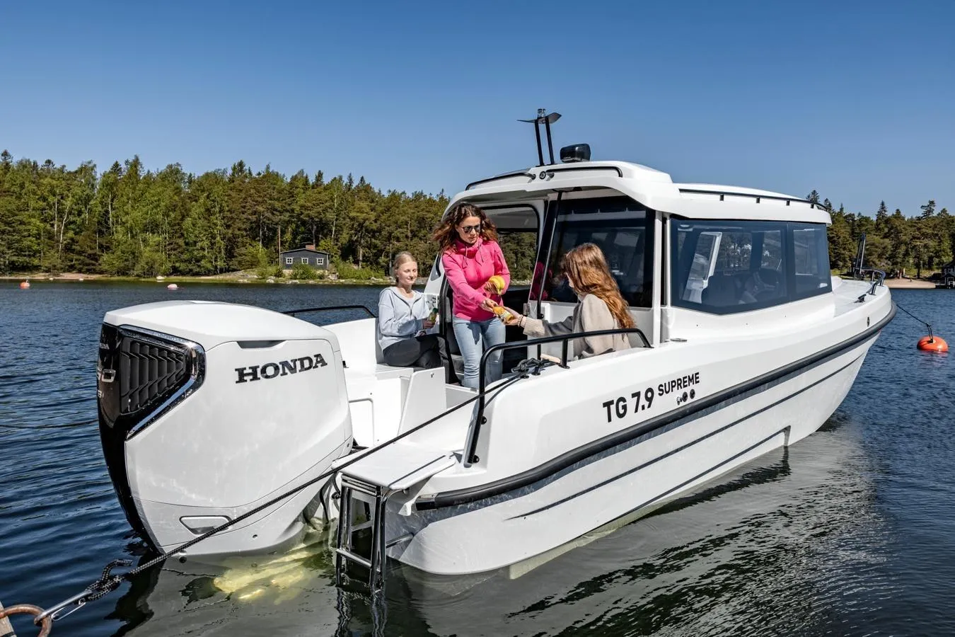 Family enjoying a ride on the 2025 TG 7.9 Supreme boat with Honda engine.
