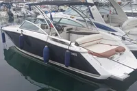 2014 Cobalt 26SD boat docked in marina, featuring sleek design and comfortable seating.