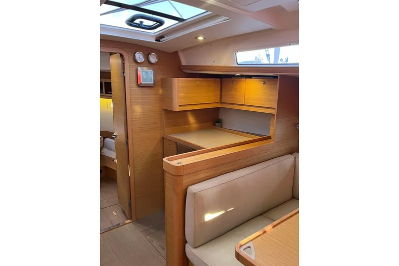 La Rosa 2 Yacht Photos Pics Interior of 2017 Dufour 460 GL yacht with wooden cabinetry and seating area.