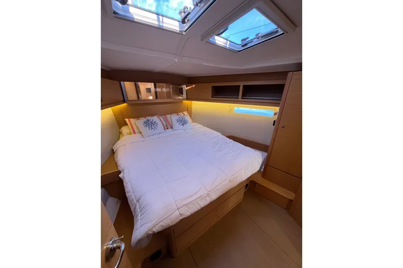 La Rosa 2 Yacht Photos Pics Cozy cabin interior of 2017 Dufour 460 GL yacht with skylight and comfortable bedding.