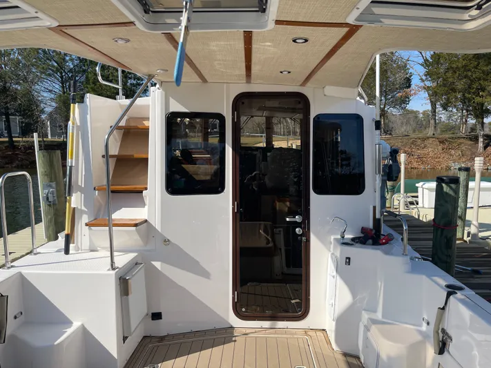 Shutter Speed II Yacht Photos Pics Ranger Tugs R-31 CB 2022, boat stern with stairs and door.