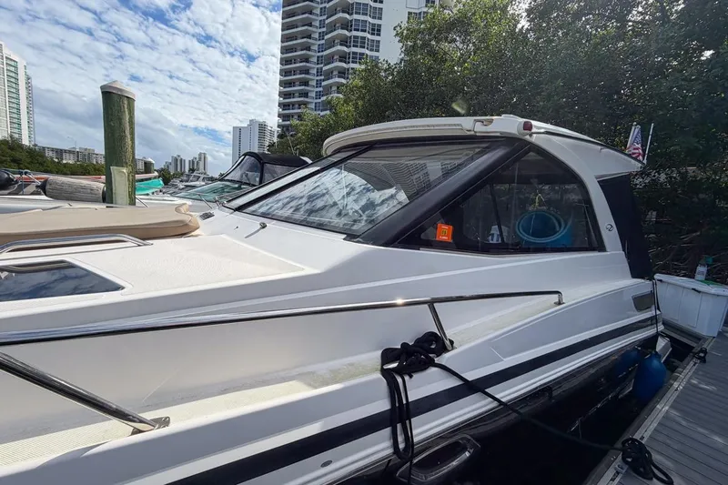 Sophia Yacht Photos Pics 2015 Regal 38 Express yacht docked near high-rise buildings under a partly cloudy sky.
