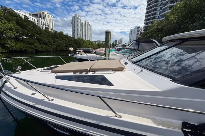 Sophia Yacht Photos Pics 2015 Regal 38 Express yacht docked in a marina with cityscape background.