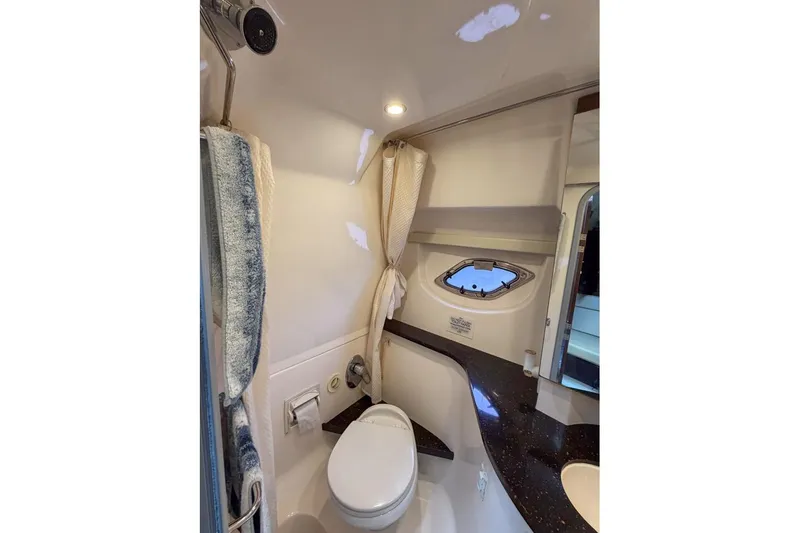 Sophia Yacht Photos Pics Bathroom interior of 2015 Regal 38 Express yacht with modern fixtures and porthole window.
