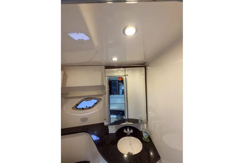 Sophia Yacht Photos Pics 2015 Regal 38 Express yacht bathroom with sink, mirror, and porthole window.
