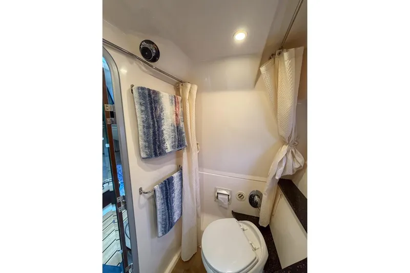 Sophia Yacht Photos Pics Bathroom interior of 2015 Regal 38 Express yacht with towels and toilet.