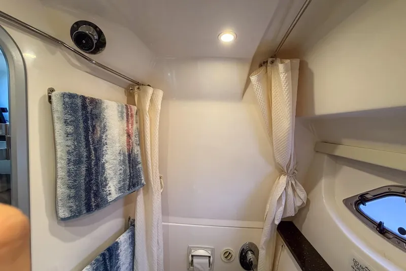 Sophia Yacht Photos Pics Bathroom interior of 2015 Regal 38 Express yacht with towels and porthole.