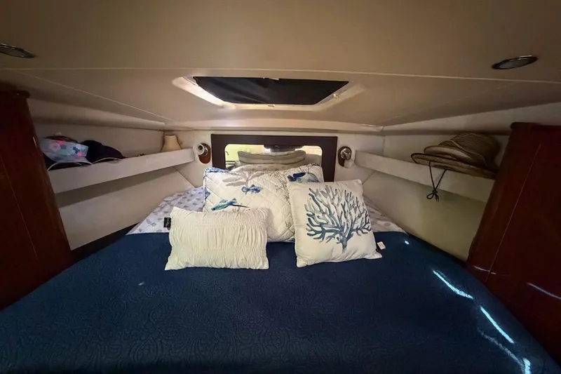 Sophia Yacht Photos Pics Cozy cabin interior of 2015 Regal 38 Express with nautical-themed bedding.