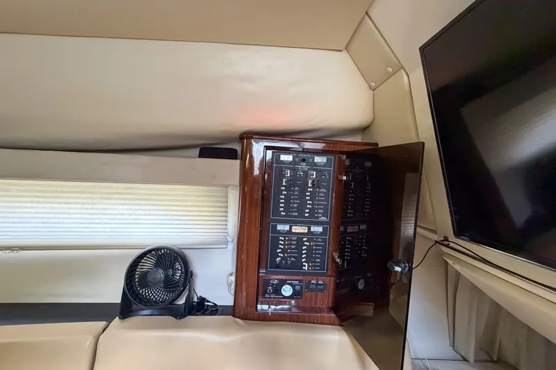 Sophia Yacht Photos Pics 2015 Regal 38 Express yacht interior with control panel, fan, and TV.