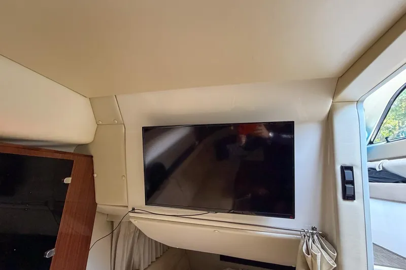 Sophia Yacht Photos Pics Interior of 2015 Regal 38 Express yacht with mounted flat-screen TV.