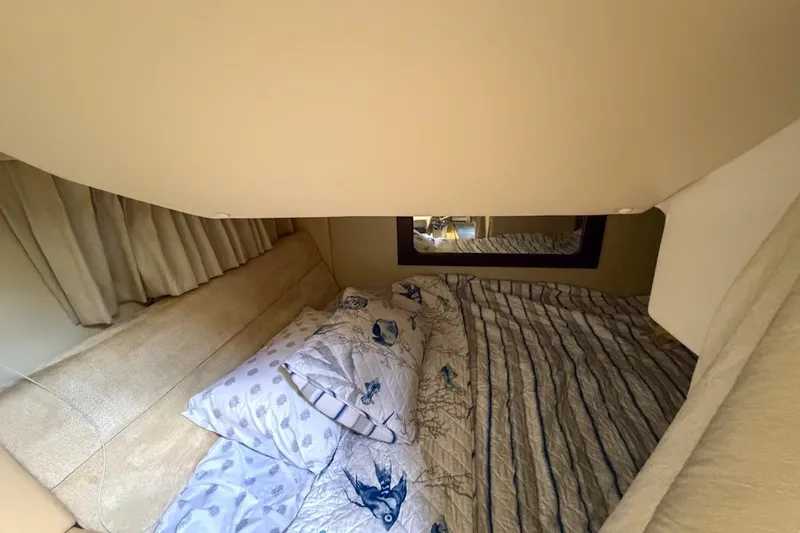 Sophia Yacht Photos Pics 2015 Regal 38 Express cabin interior with cozy bedding and mirror.
