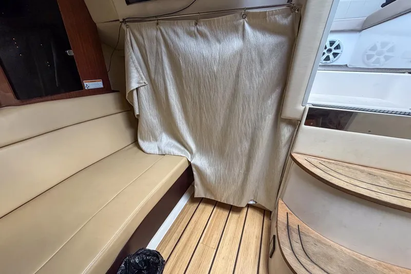 Sophia Yacht Photos Pics Interior of 2015 Regal 38 Express yacht with beige seating and wooden flooring.