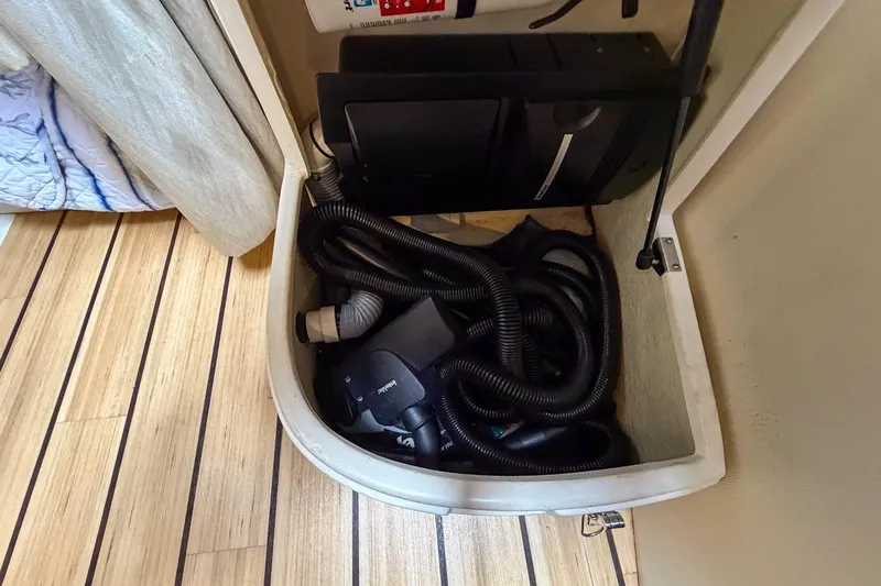 Sophia Yacht Photos Pics Storage compartment in 2015 Regal 38 Express boat with coiled hoses and equipment.