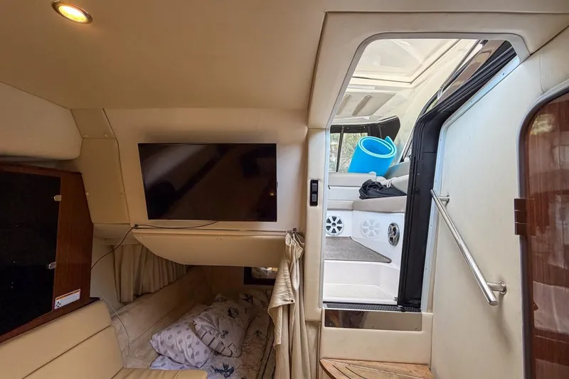 Sophia Yacht Photos Pics 2015 Regal 38 Express yacht interior with TV, seating, and stairs to deck.