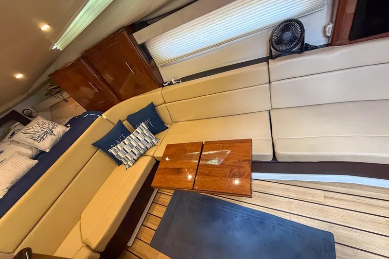 Sophia Yacht Photos Pics Luxurious interior of 2015 Regal 38 Express yacht with beige seating and wooden accents.