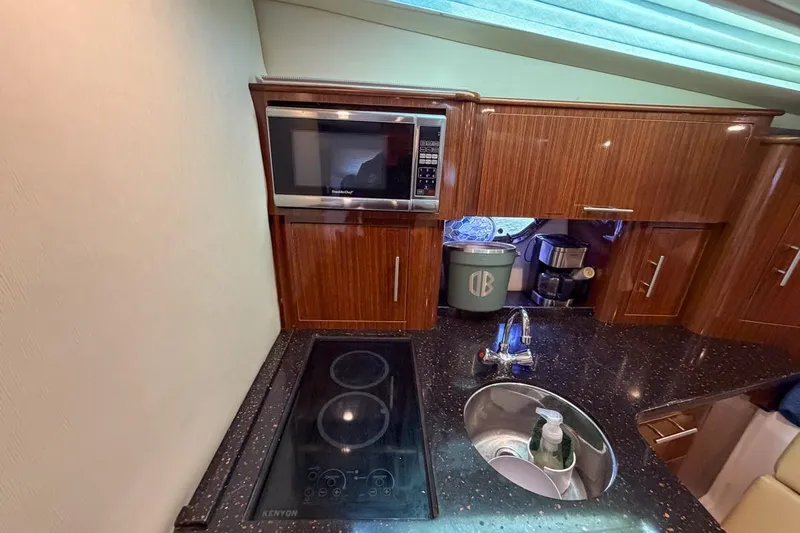 Sophia Yacht Photos Pics 2015 Regal 38 Express yacht kitchen with microwave, stove, and sink.