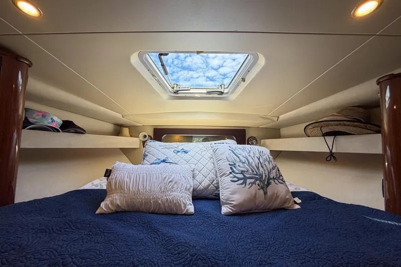 Sophia Yacht Photos Pics Cozy cabin interior of 2015 Regal 38 Express yacht with skylight and decorative pillows.