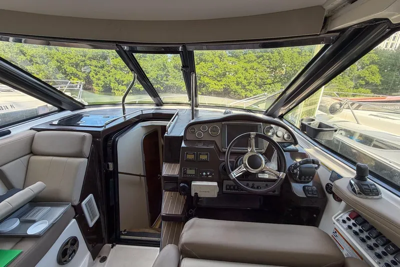 Sophia Yacht Photos Pics 2015 Regal 38 Express boat cockpit with steering wheel and control panel.