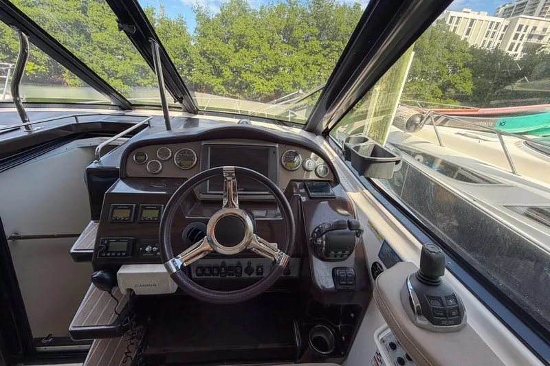 Sophia Yacht Photos Pics 2015 Regal 38 Express boat helm with steering wheel and control panel.