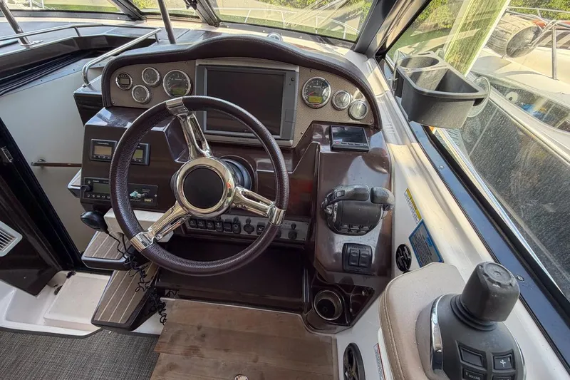 Sophia Yacht Photos Pics 2015 Regal 38 Express boat helm with steering wheel and control panel.
