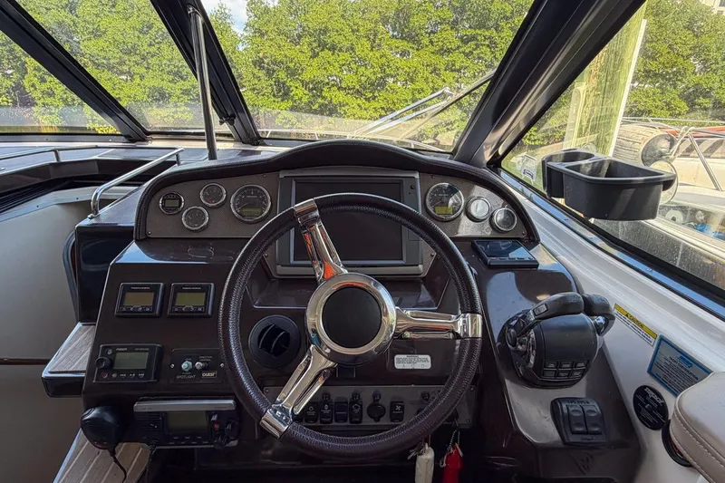 Sophia Yacht Photos Pics 2015 Regal 38 Express boat helm with steering wheel and control panel.