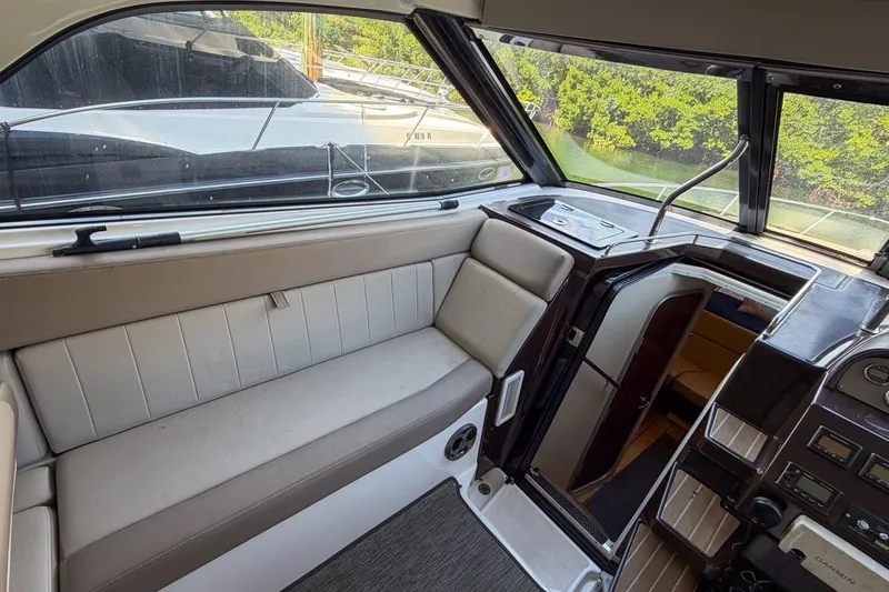 Sophia Yacht Photos Pics Interior of 2015 Regal 38 Express yacht with seating and control panel.