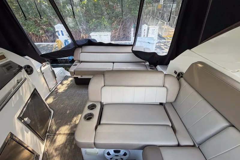 Sophia Yacht Photos Pics Interior of 2015 Regal 38 Express yacht with beige seating and cup holders.