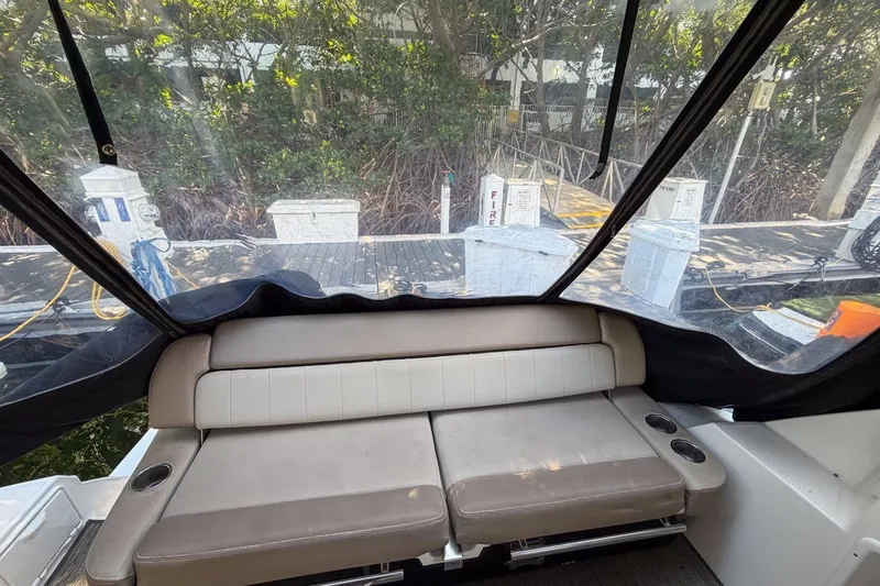 Sophia Yacht Photos Pics 2015 Regal 38 Express boat interior with cushioned seating and marina view.