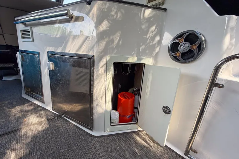 Sophia Yacht Photos Pics 2015 Regal 38 Express yacht interior storage compartment with open door and visible equipment.