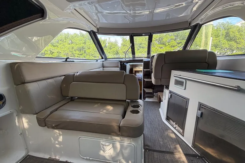 Sophia Yacht Photos Pics Interior of 2015 Regal 38 Express yacht with seating and kitchenette.