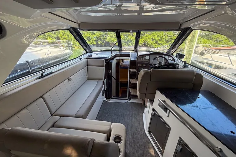 Sophia Yacht Photos Pics Interior of 2015 Regal 38 Express yacht with seating, helm, and kitchenette.