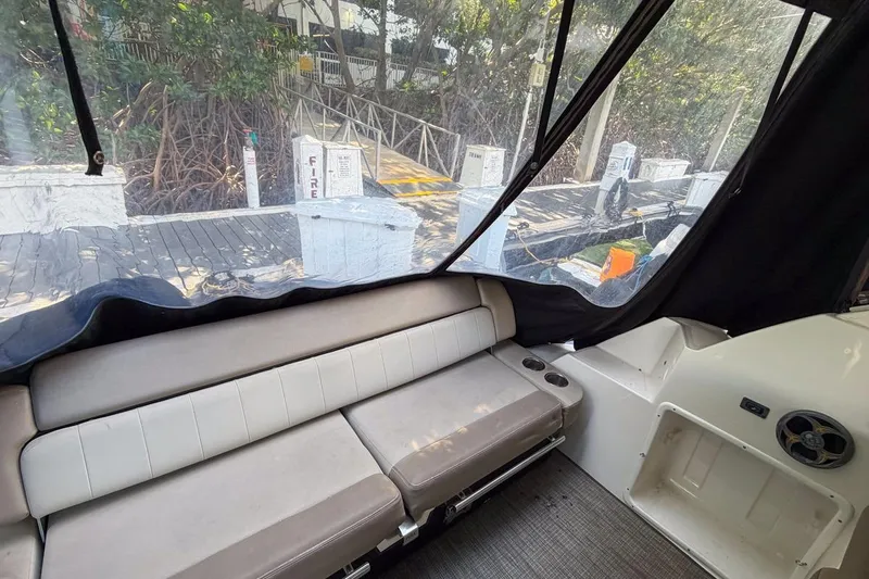 Sophia Yacht Photos Pics Interior view of 2015 Regal 38 Express boat with seating and dockside view.