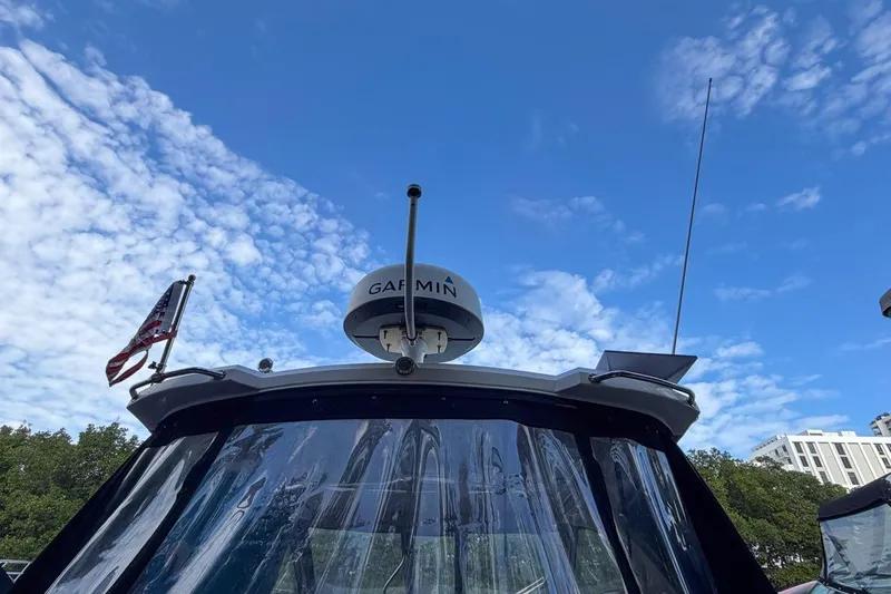 Sophia Yacht Photos Pics 2015 Regal 38 Express boat with Garmin radar, clear sky background.