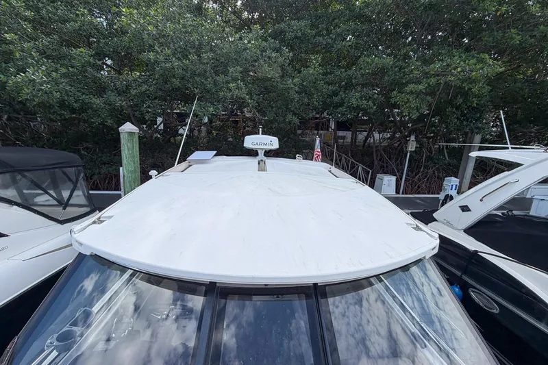 Sophia Yacht Photos Pics 2015 Regal 38 Express boat docked, featuring a white roof and Garmin equipment.