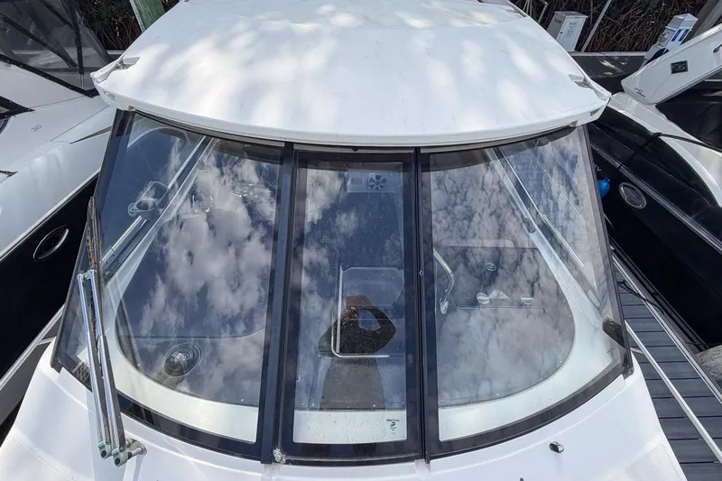 Sophia Yacht Photos Pics 2015 Regal 38 Express yacht with reflective windows and sleek design.