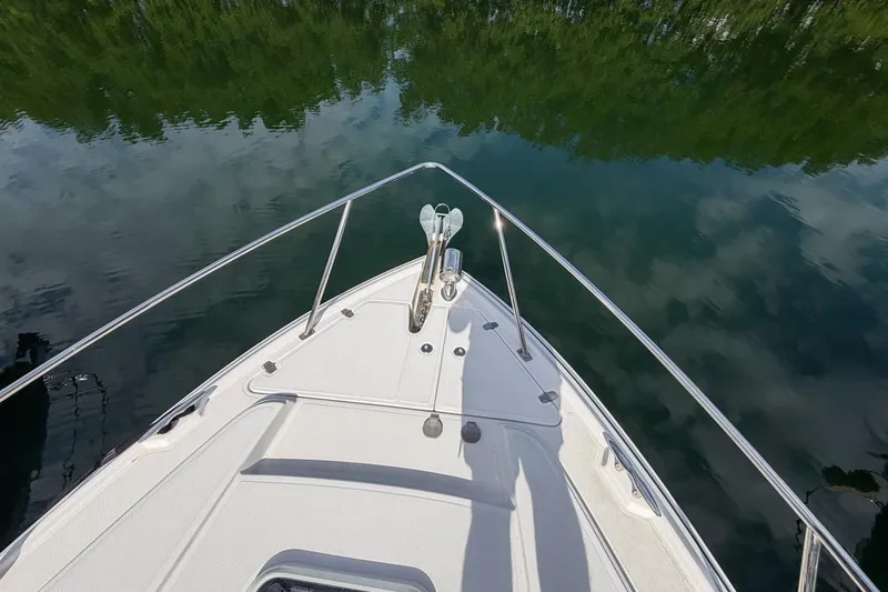 Sophia Yacht Photos Pics Bow view of 2015 Regal 38 Express boat on calm water.