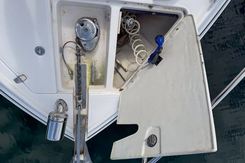 Sophia Yacht Photos Pics Open anchor locker on 2015 Regal 38 Express boat, showing anchor chain and storage.