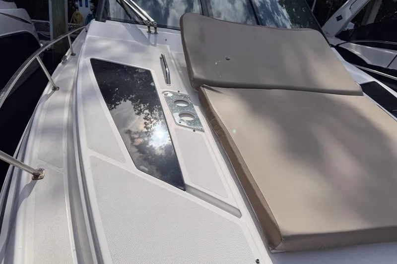 Sophia Yacht Photos Pics 2015 Regal 38 Express boat deck with sunpad and stainless steel railings.