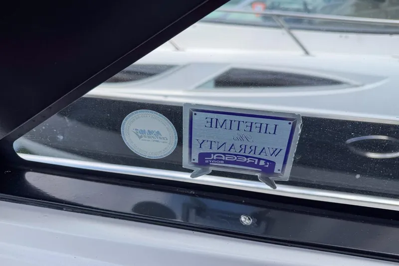 Sophia Yacht Photos Pics 2015 Regal 38 Express boat window with lifetime warranty sticker.