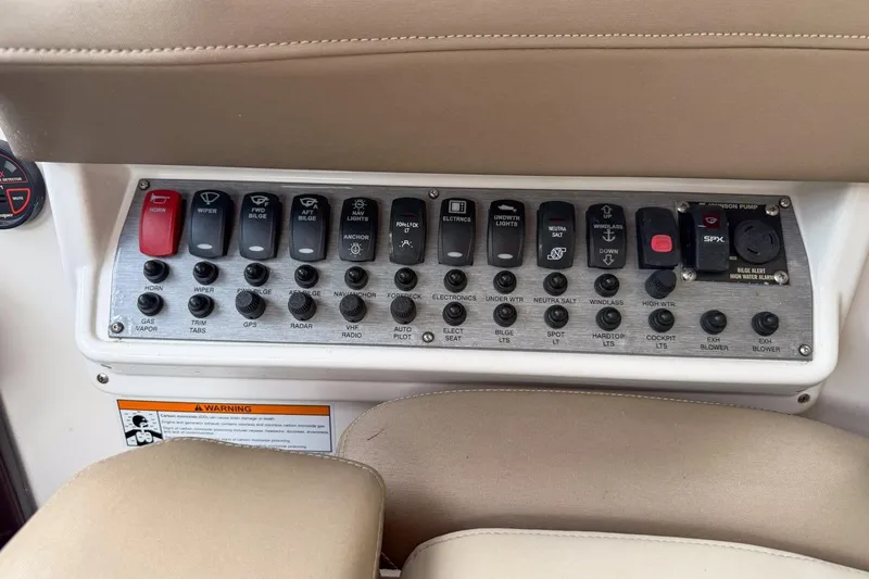 Sophia Yacht Photos Pics Control panel of a 2015 Regal 38 Express boat with labeled switches and buttons.