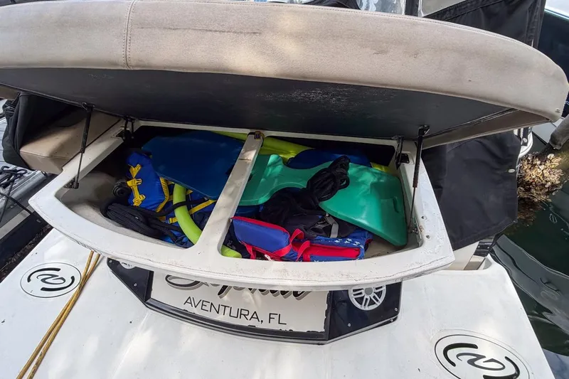 Sophia Yacht Photos Pics Open storage compartment on 2015 Regal 38 Express boat, filled with water sports gear.