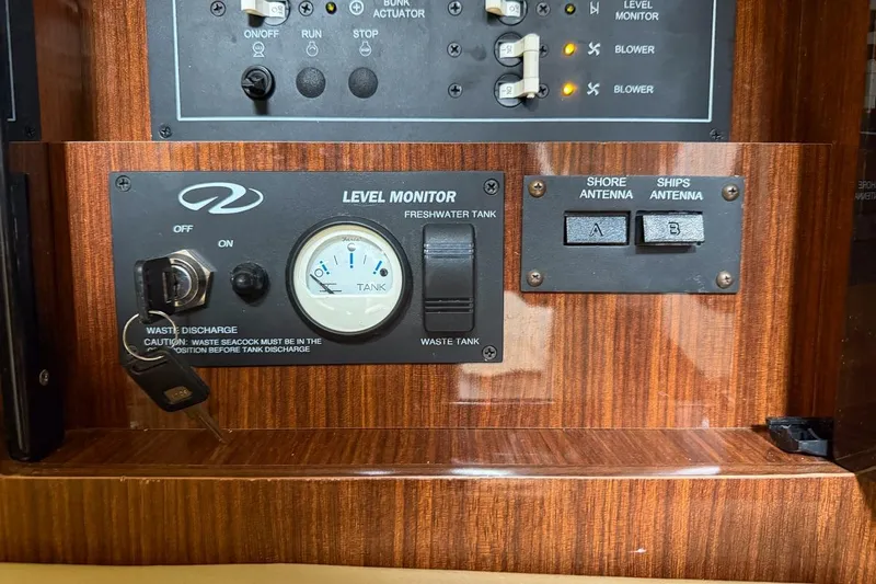 Sophia Yacht Photos Pics Control panel of a 2015 Regal 38 Express boat with level monitor and antenna switches.