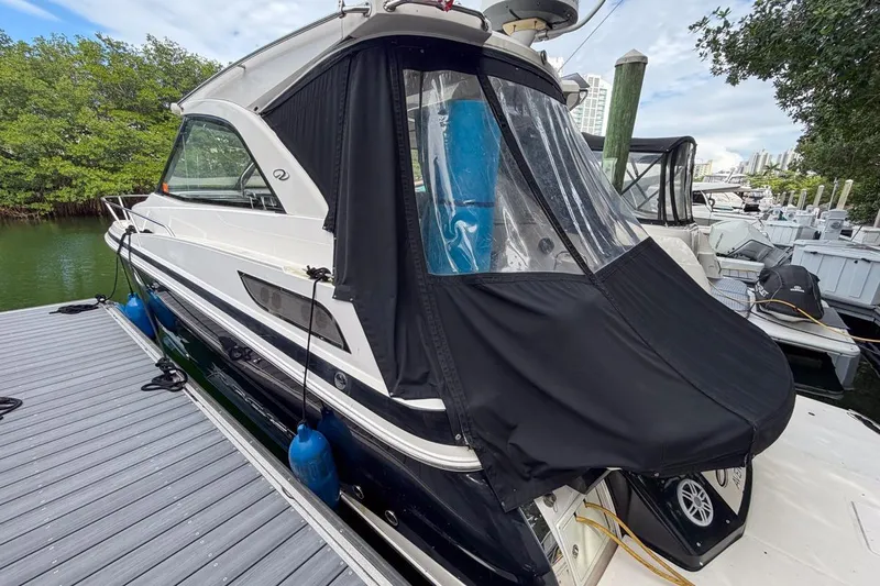 Sophia Yacht Photos Pics 2015 Regal 38 Express yacht docked with black canopy and blue fenders.